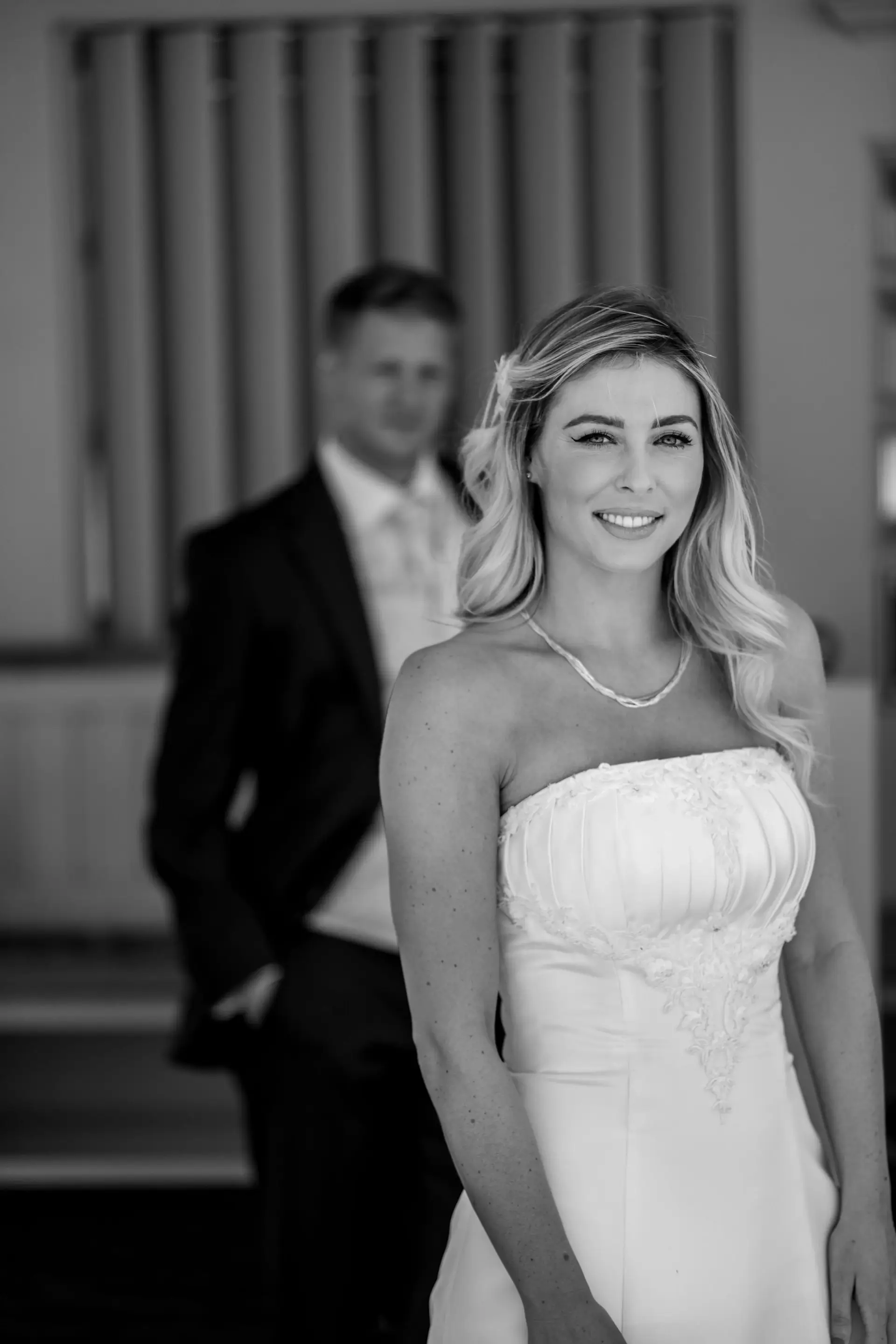 Black and white portrait of smiling bride in wedding dress