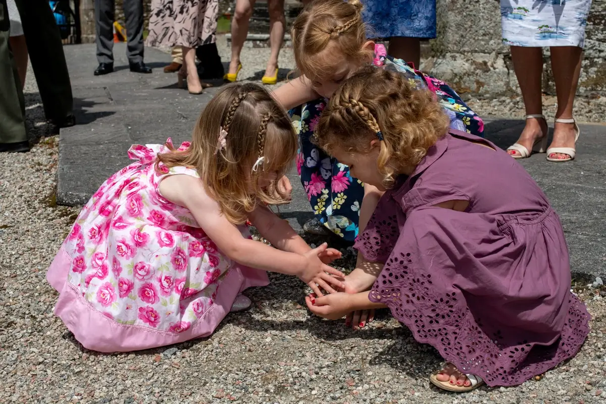 Children playing together outdoors in colorful dresses