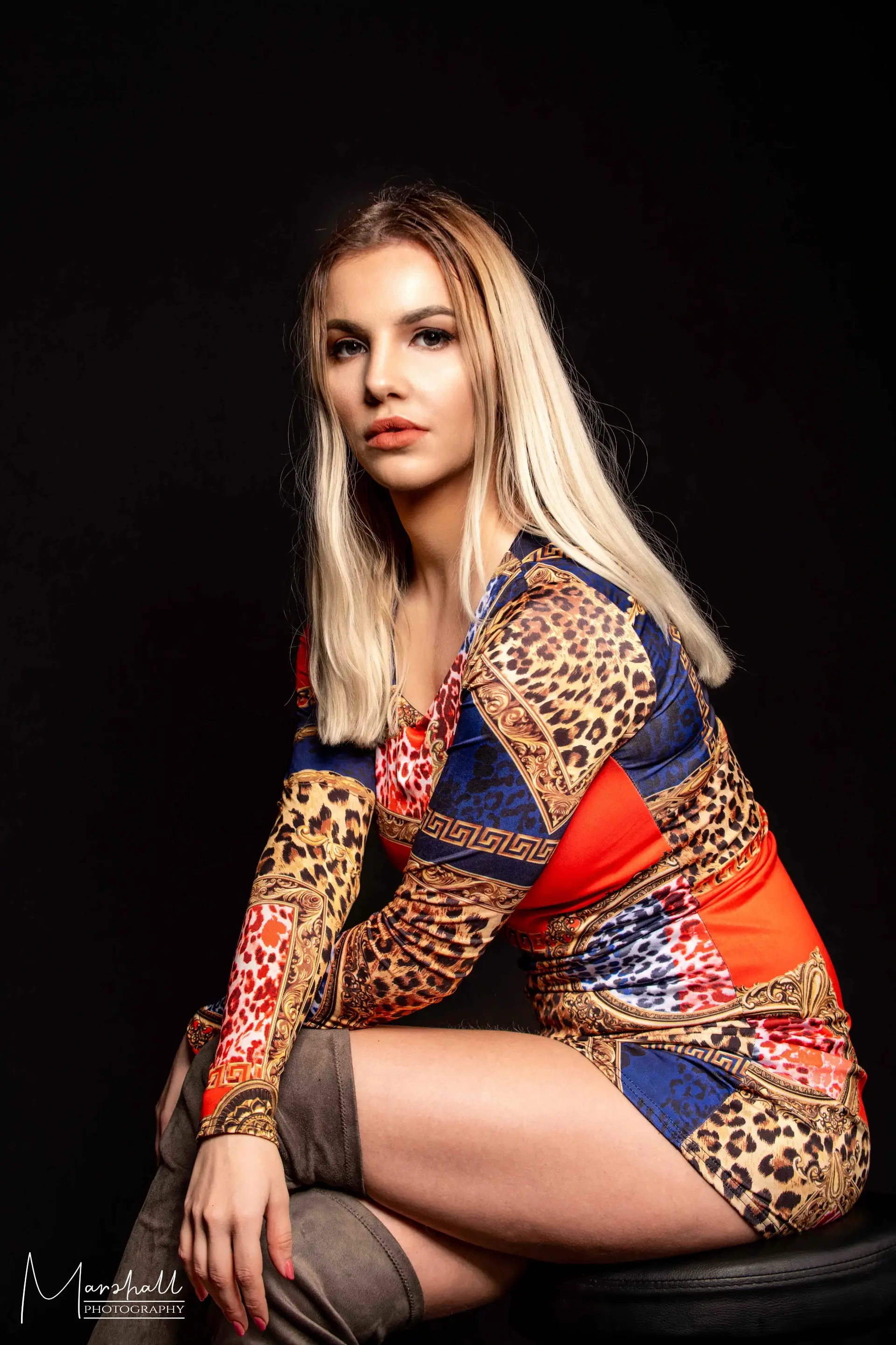 Blonde model in colorful patterned jacket studio headshot